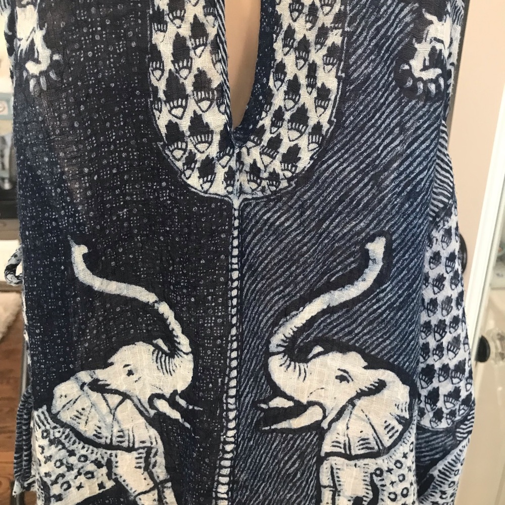 Free People elephant sheer blouse with side ties and peek view back with snap.
